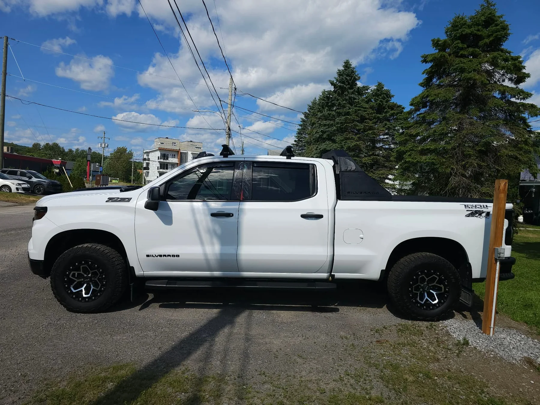 A customer’s white pickup showing a clean reflective finish