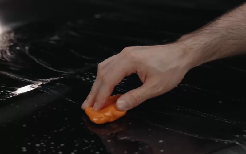 Working a clay bar over the paint.