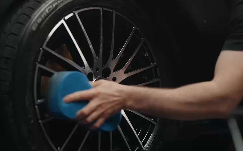 Washing a wheel during a Magic Shield detail.