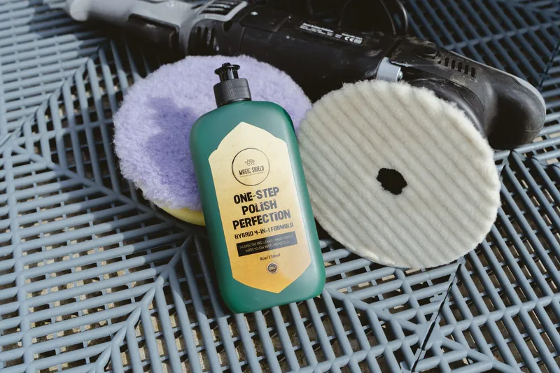 Magic Shield One Step Polish beside a polishing pad and towels.